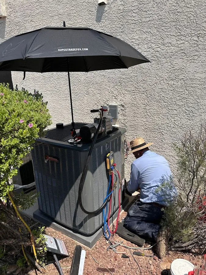 HVAC technician performing outdoor AC maintenance in Otsego